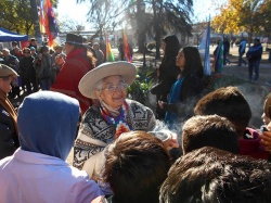 Teresita Cruz sahumando a los pibes escolares al iniciar la ceremonia en Moreno, el 21-6-18.